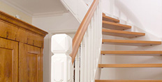 Holztreppe mit weißem Treppengeländer